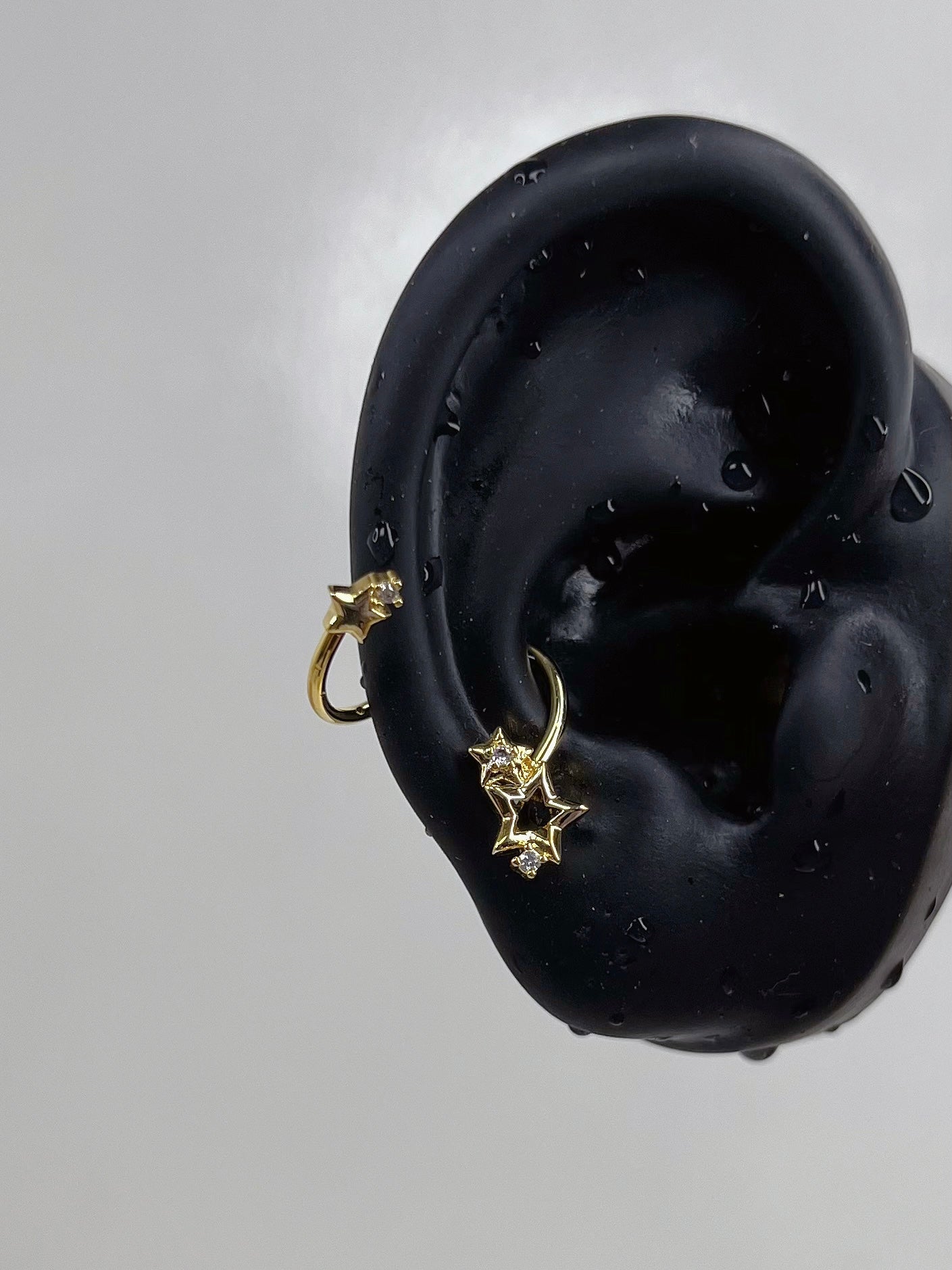 Gold Swirling Star Conch Earrings