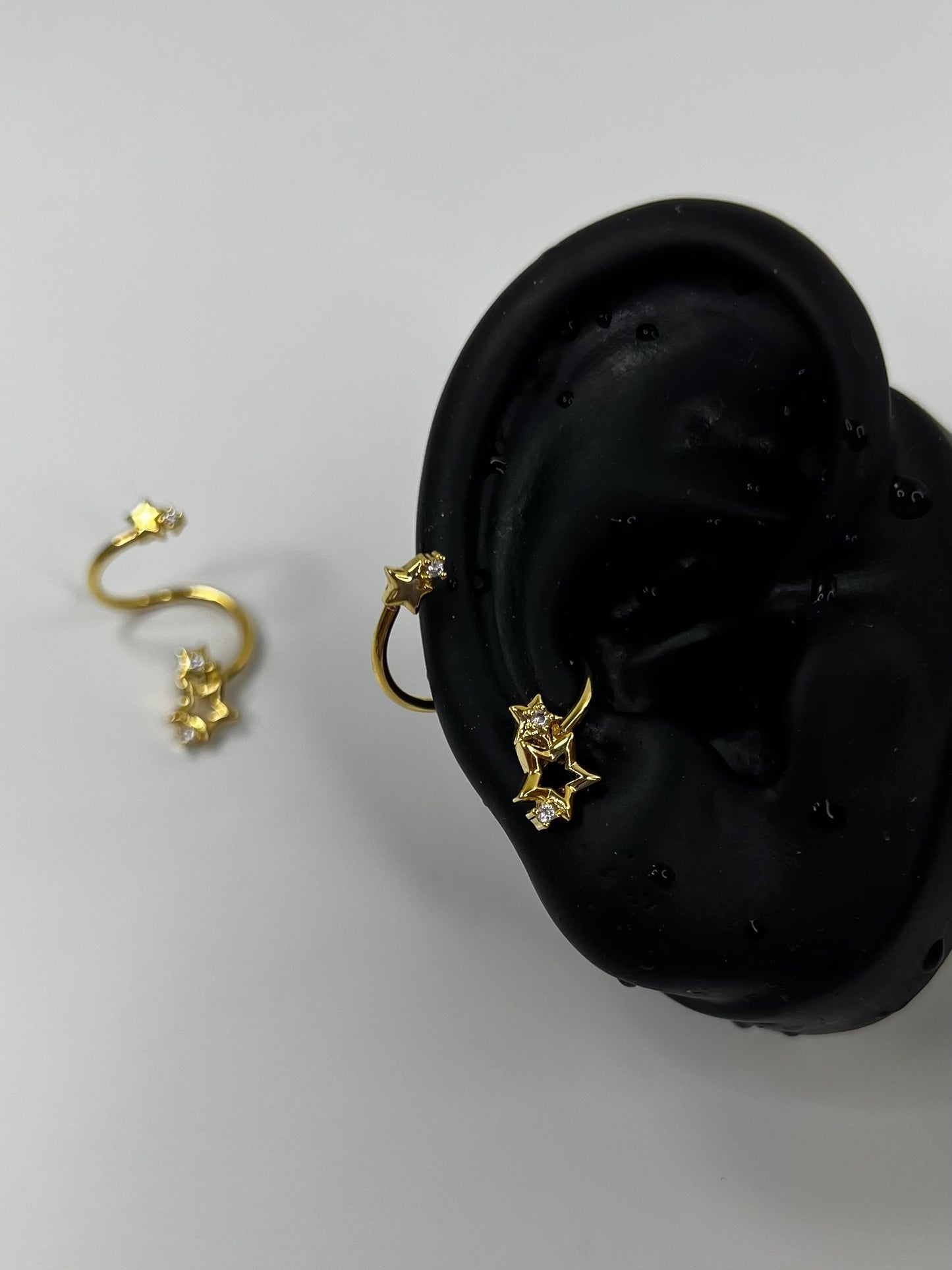 Gold Swirling Star Conch Earrings
