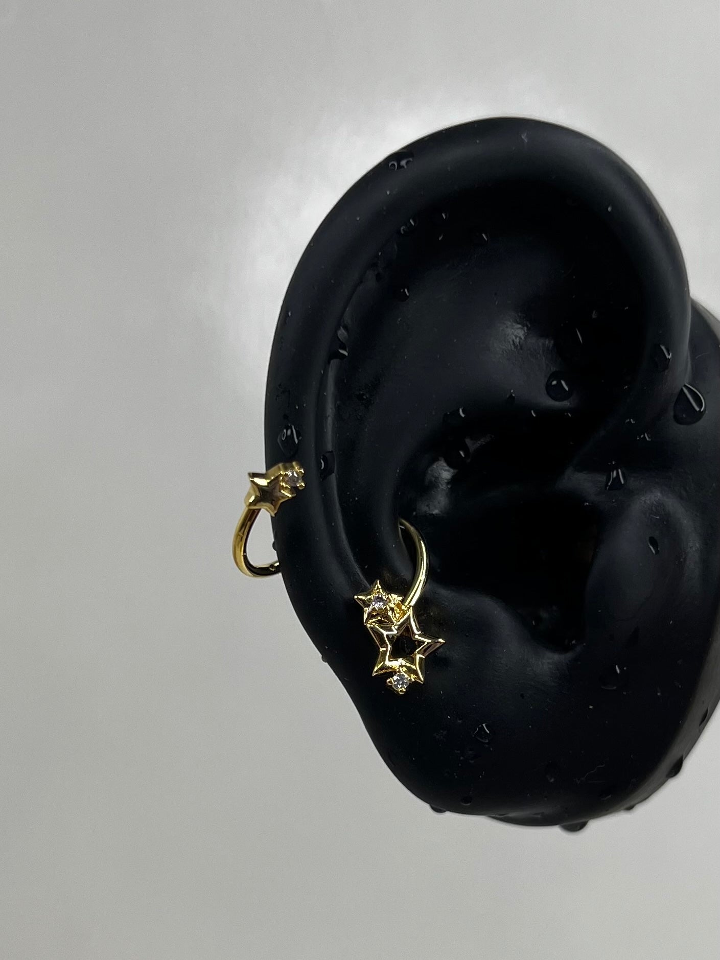 Gold Swirling Star Conch Earrings