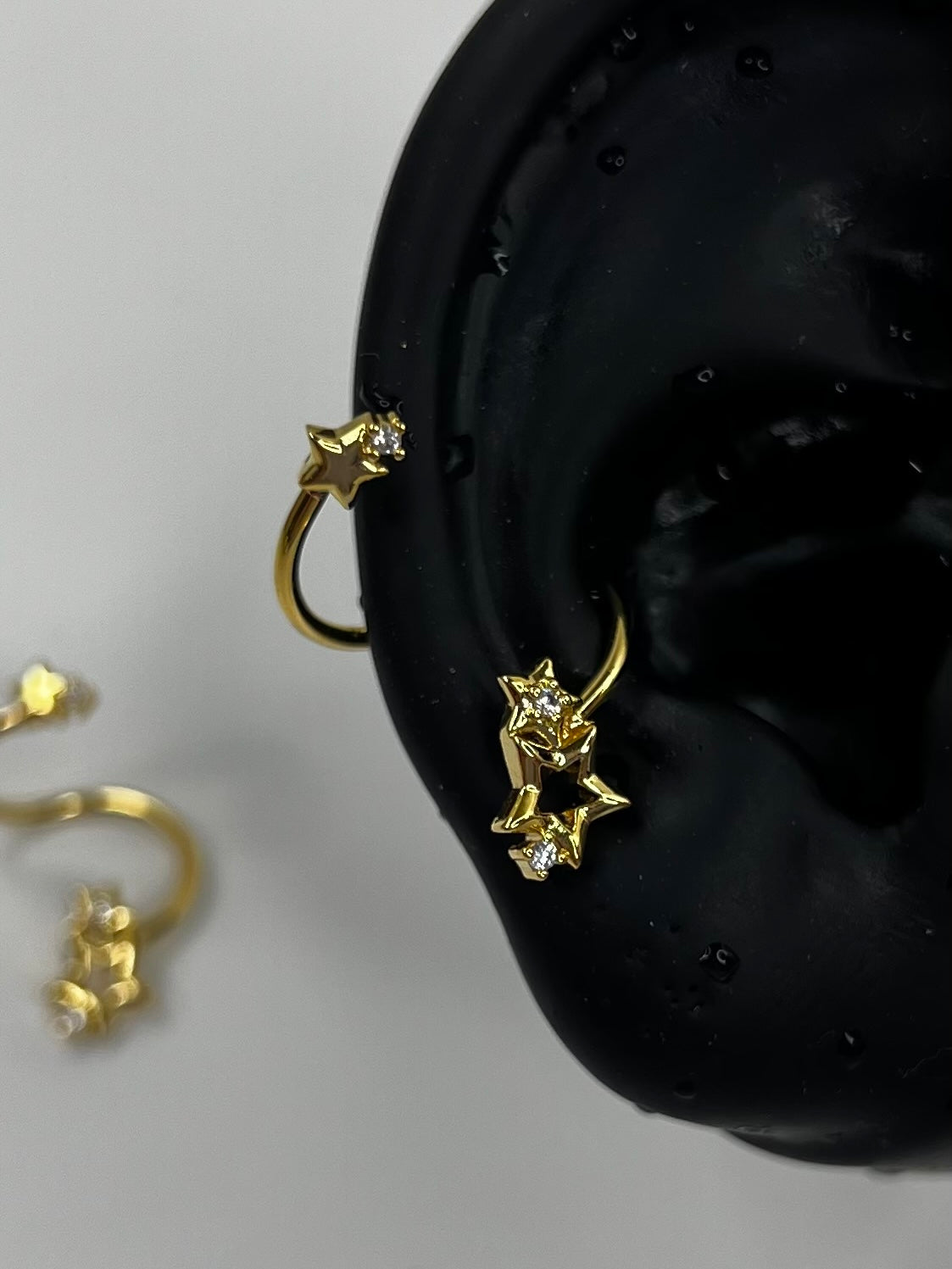 Gold Swirling Star Conch Earrings
